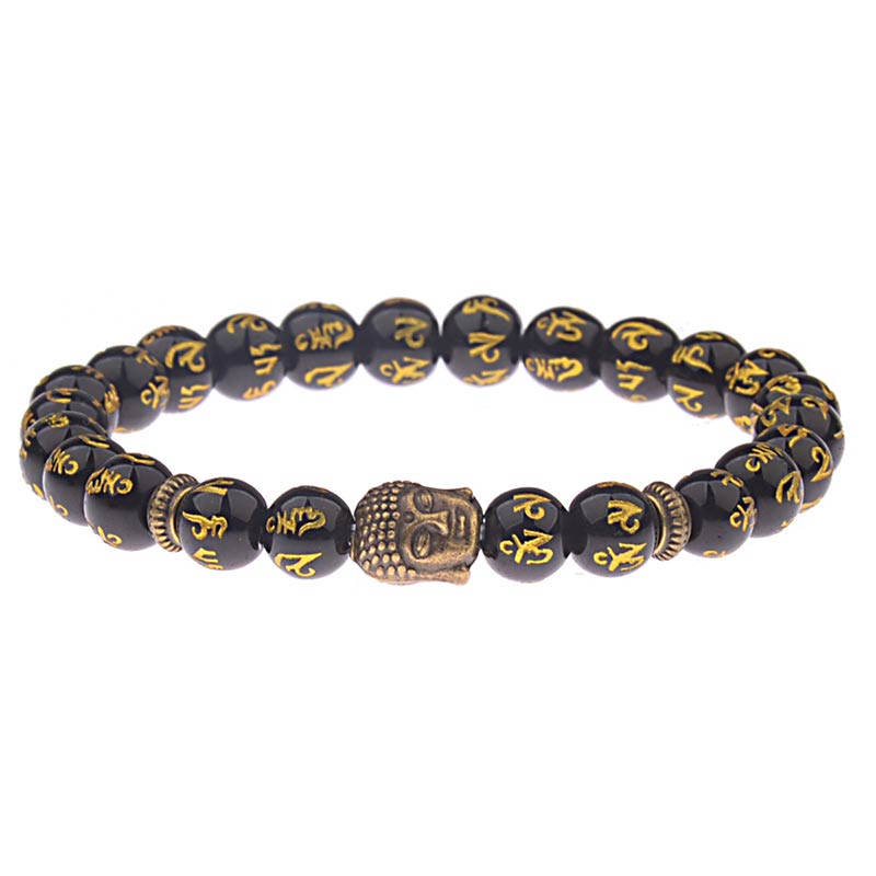 Tibetan Buddha Om Mani Padme Hum Amulet Bracelet - black obsidian beads with gold Tibetan Buddhist mantra, antique bronze Buddha head charm, metal spacer accents, prayer bracelet on dark textured background