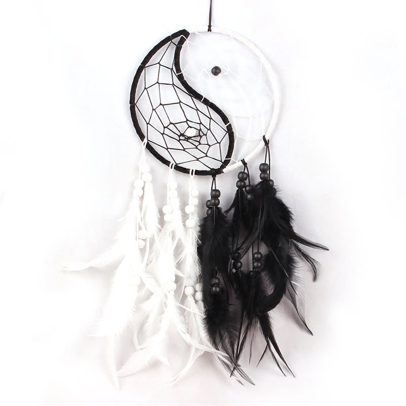 Yin Yang Dream Catcher with Feathers – Black and white dreamcatcher hanging on tree branch, boho decor