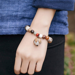 Bodhi Seed Lotus Bracelet – Worn lifestyle shot on wrist with casual outfit, natural seed mala