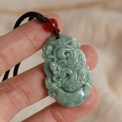 Jade Zodiac Prosperity Necklace – Dragon pendant held in hand showing scale, close-up, authentic