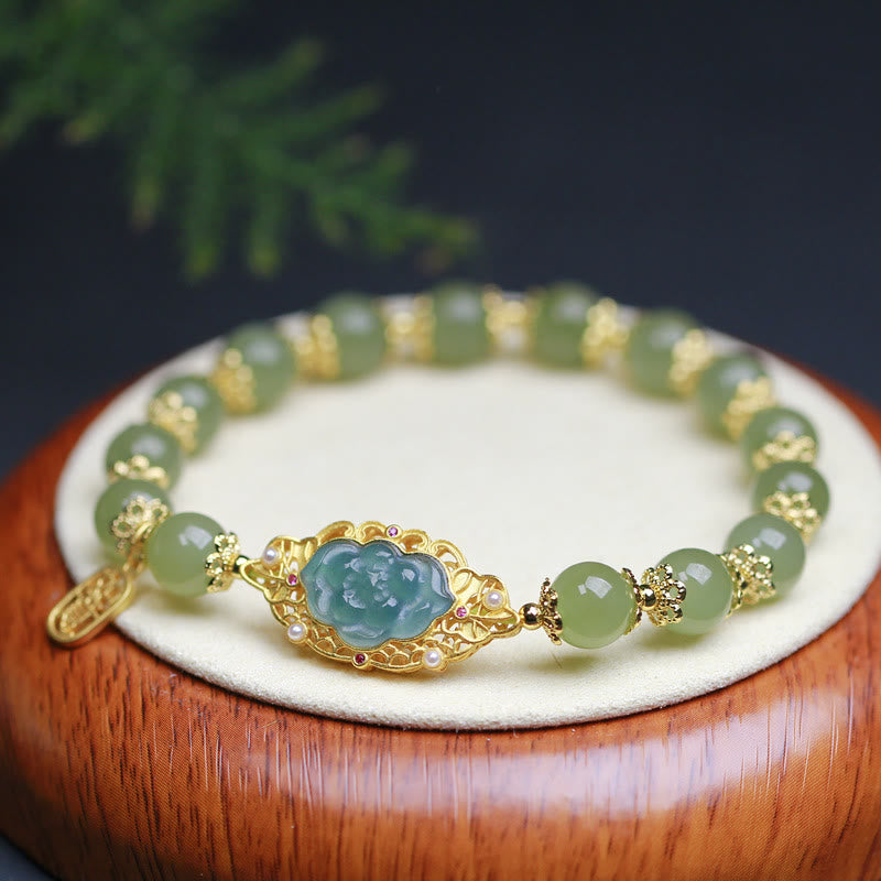 Hetian Jade Lotus Bracelet - carved lotus centerpiece with celadon jade beads on rosewood stand, jade bracelet