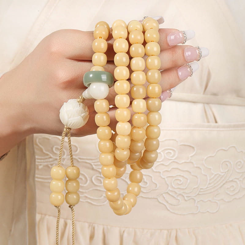 Bodhi Seed Lotus Dzi Bracelet - Hand cradling cream bodhi beads with sage green ring accent, prayer beads