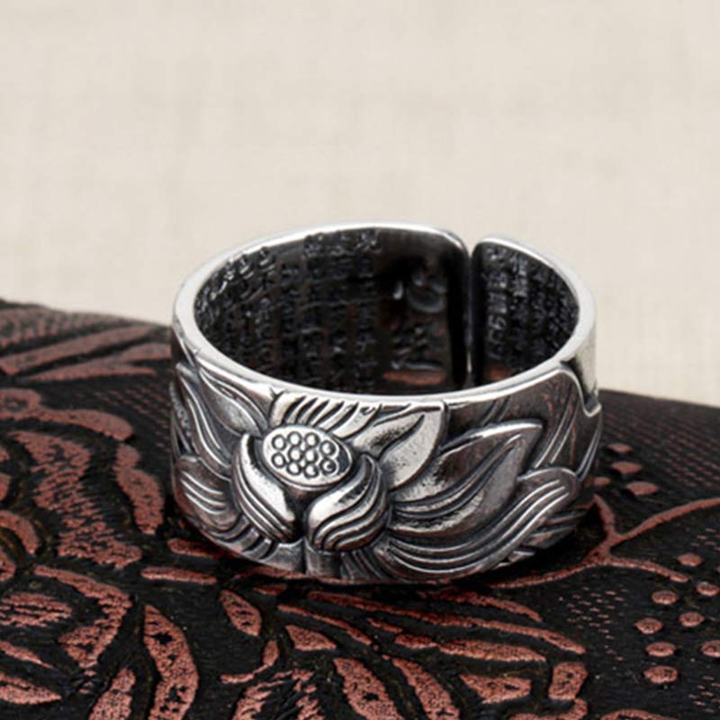 999 Silver Lotus Ring – detailed lotus bloom relief on dark embroidered fabric