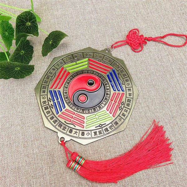 Feng Shui Bagua Map Mirror - Bagua mirror ornament with yin-yang symbol, colored trigrams, red tassel and Chinese knot, bron.