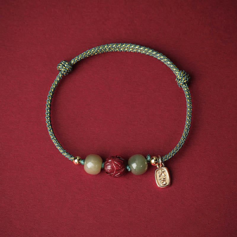 Hetian Jade Cinnabar Lotus Bracelet – Teal and gold braided cord with jade beads and lotus charm, teal bracelet