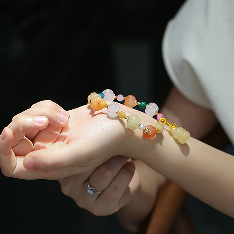 Golden Silk Jade Gourd Bracelet – Hands together showing bracelet, ring detail