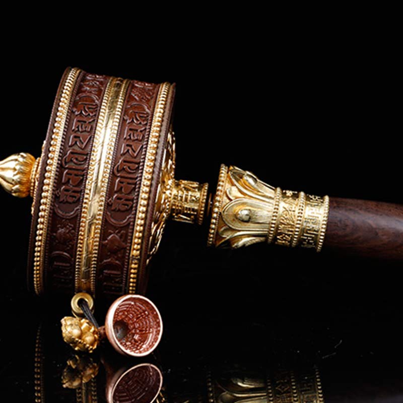 Copper Prayer Wheel – Low angle close-up of gold-inlaid wood cylinder, spiritual balance