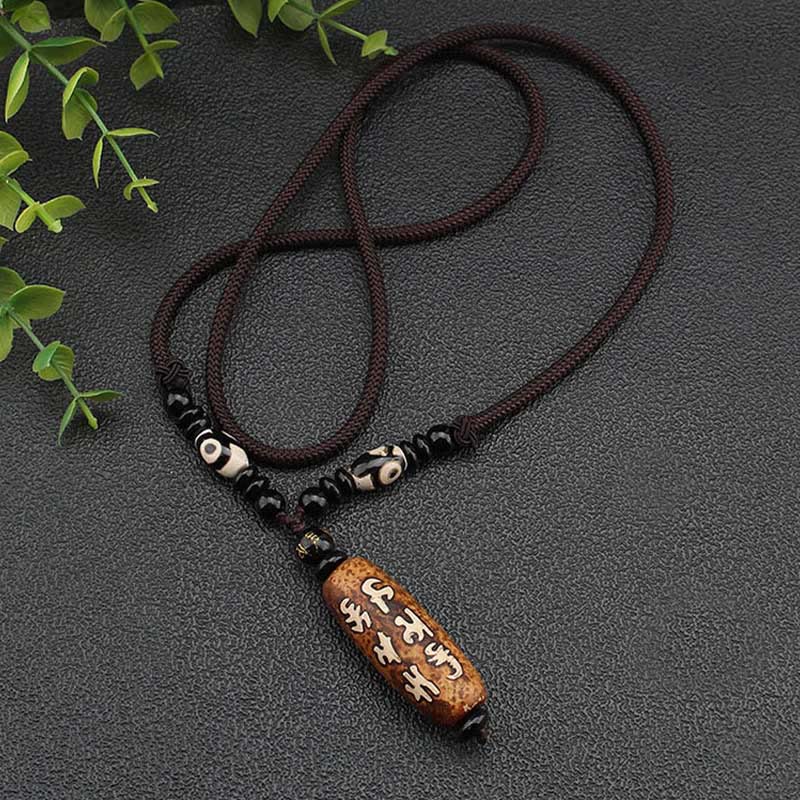 Dzi Bead Necklace – Six-character mantra pendant with braided cord and eucalyptus accent, grounding