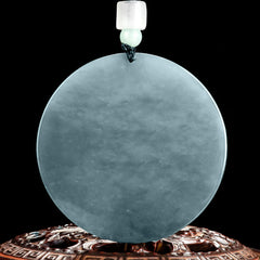 Kwan Yin Jade String Necklace – reverse side of plain jade bi disc on carved wooden stand, displaying natural stone texture and milky interior, authenticity showcase