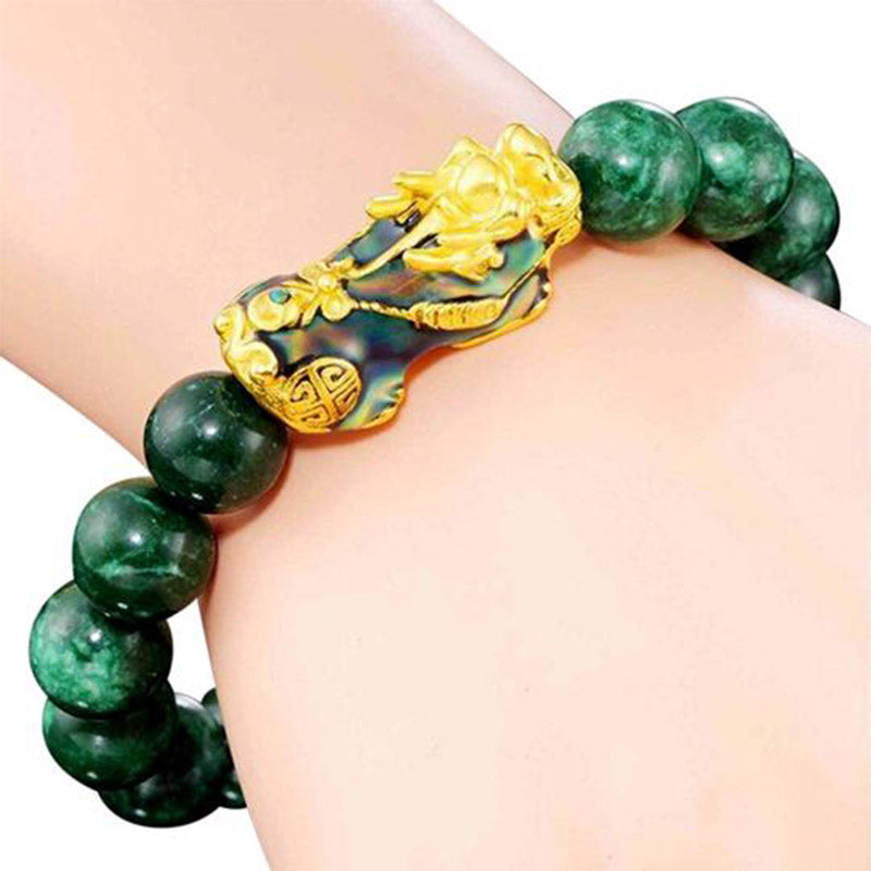 PiXiu Jade Bracelet – Wrist shot on white background showing gold PiXiu and green jade beads