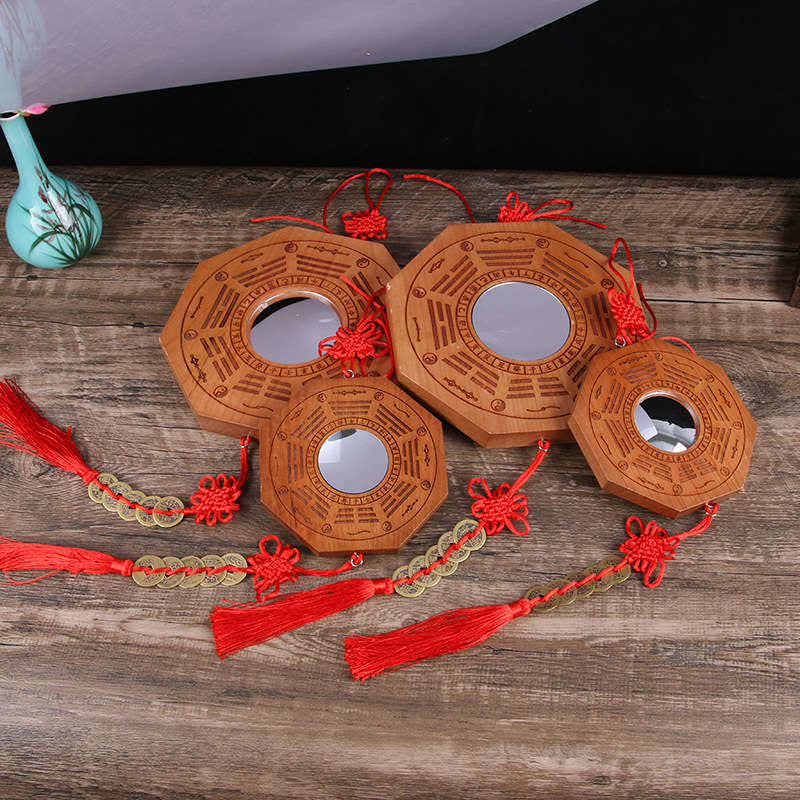 Peach Wood Bagua Map - four octagonal bagua mirrors with red tassels and coin strings on wood, feng shui