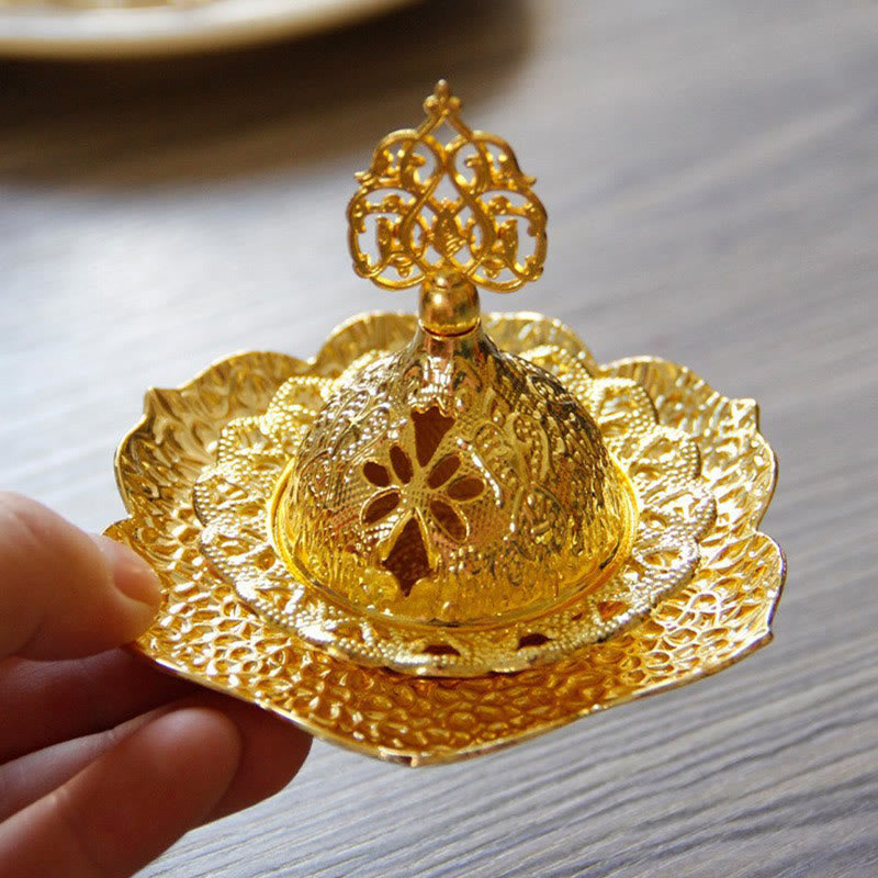 Gold Leaf Coaster Incense Burner with smoke wisps, lotus base held by fingers, alloy incense holder