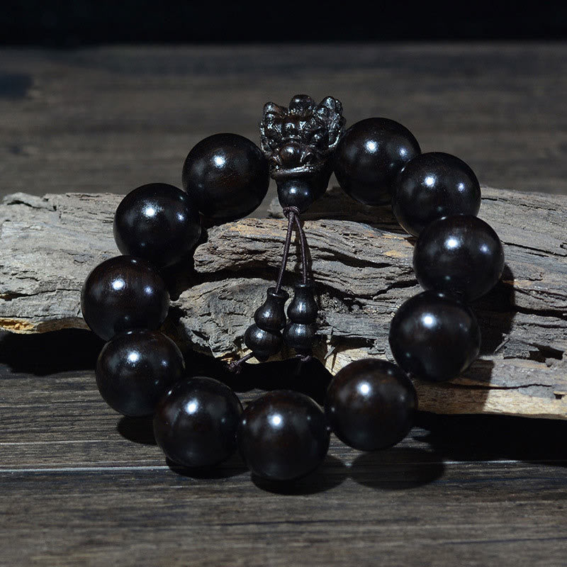Multi-Wood Dragon Bracelet - Black polished beads with metal guardian lion charm on driftwood, Defiance