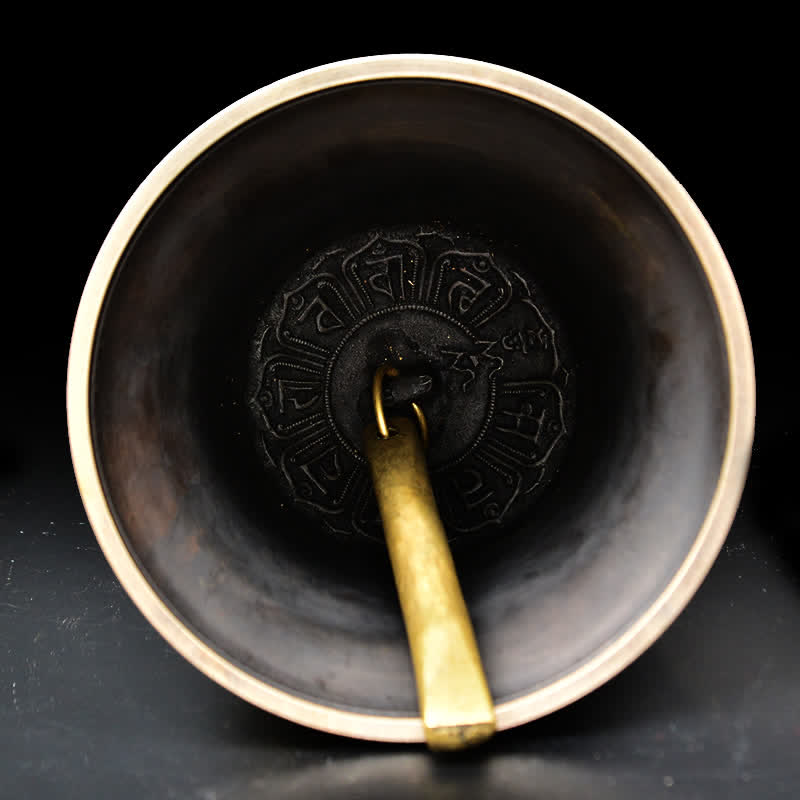 Tibetan Buddha Dragon Bell overhead view showing interior striker and Tibetan mantra engraving, zen, calming