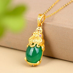 Natural Jade Pixiu Necklace – green jade pendant on beige fabric with gold chain, balance