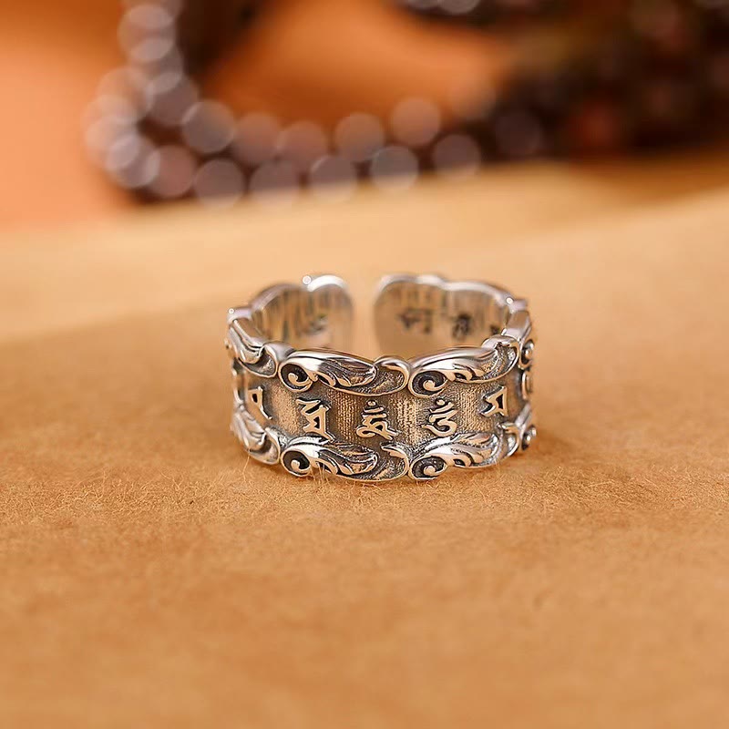Tibetan Om Mani Padme Hum Ring – Low angle of adjustable cuff showing mantra text and scrollwork borders, antique silver ring