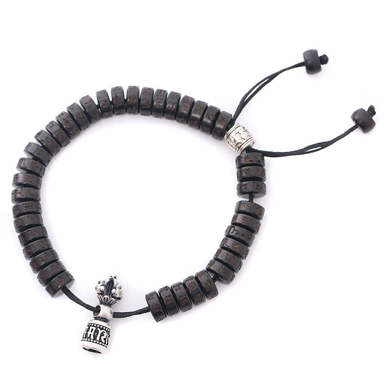 Coconut Shell Dorje Vajra Bracelet – Flat lay with silver prayer wheel pendant and lotus crown finial on black cord, Tibet...