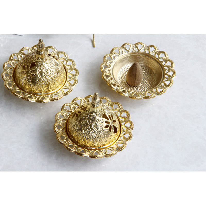 Tibetan Gold Mini Meditation Incense Burner – Gold dome lid lifted by hand, incense cone in base, intricate filigree border