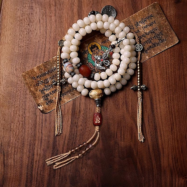 108 Mala Beads Bracelet – Red agate accents, guru bead, wood flat lay