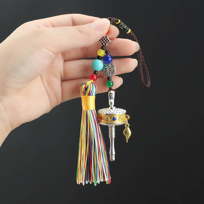 Tibetan Prayer Wheel Tassel – Prayer wheel keychain with tassel and beads in open palm, Tibetan charm