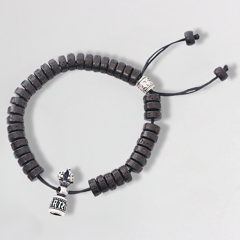 Coconut Shell Dorje Vajra Bracelet – Top-down view of full bracelet with dark beads and silver vajra charm, prayer bracelet Hauptbild