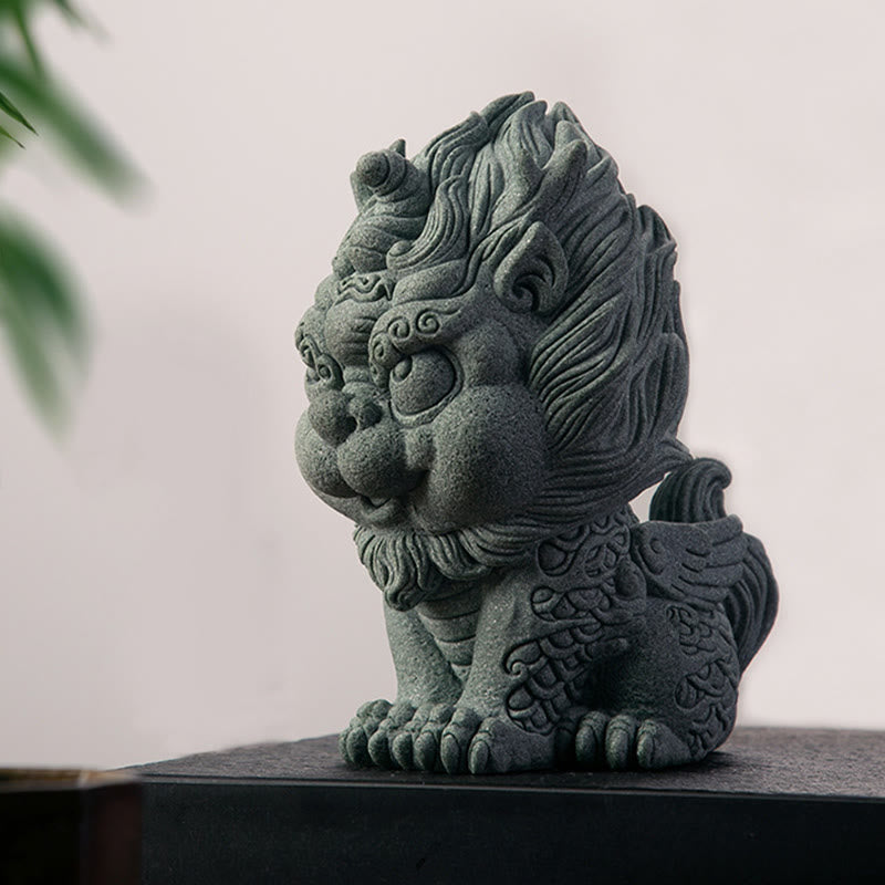 PiXiu Sandstone Statue – Side profile on black surface, white wall with plant, minimalist statue