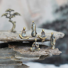 Mini Metal Meditation Buddha Decoration – five bronze monk figurines on layered zen rocks with pine tree, serenity and peace