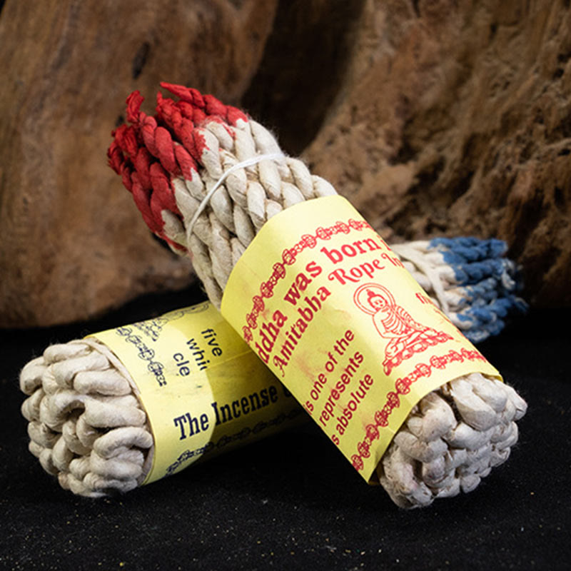 Nepal Rope Incense - two bundles with red and blue tips on wood, healing