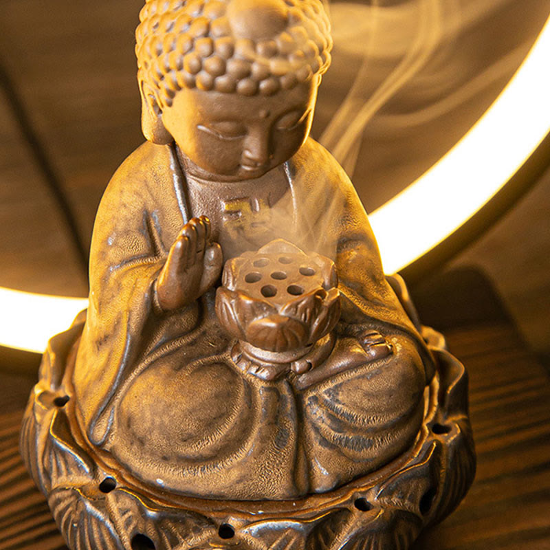 Child Buddha incense burner close-up with ring light halo, smoke rising from lotus holder, warm glow detail