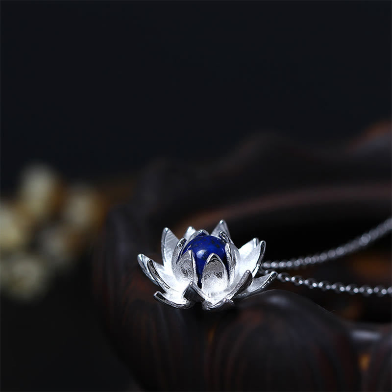Lapis Lazuli Lotus Necklace - close-up on black background highlighting silver petal texture, lapis pendant