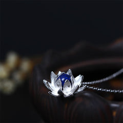 Lapis Lazuli Lotus Necklace - close-up on black background highlighting silver petal texture, lapis pendant