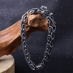 Dragon Titanium Steel Luck Bracelet Bangle - dragon head clasp on driftwood prop against dark background, bold masculine