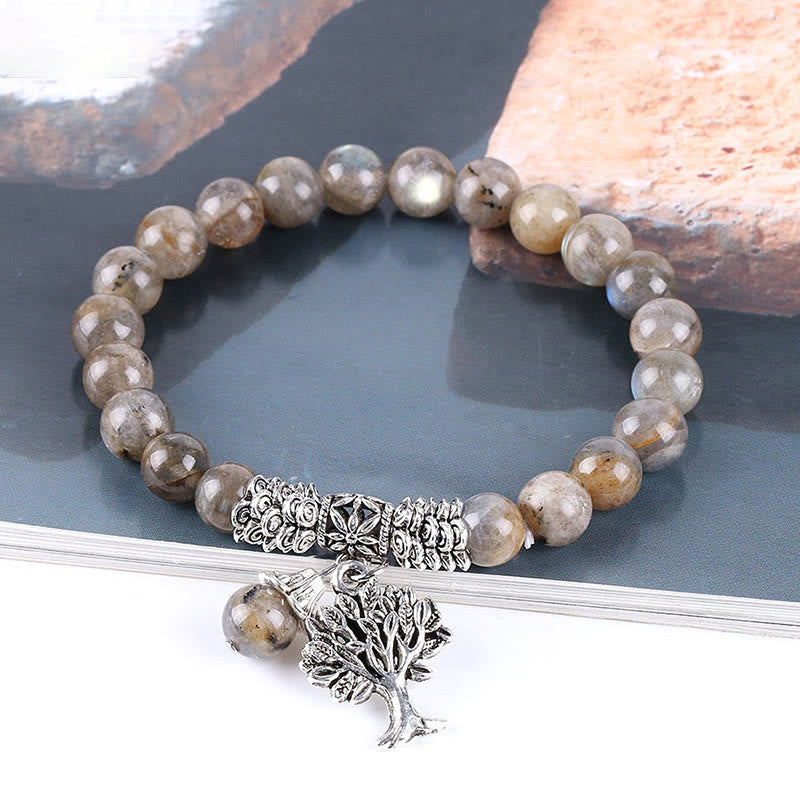 Tree of Life labradorite bracelet with grayish-brown beads and characteristic iridescent schiller, silver-toned metal spacers and tree charm.
