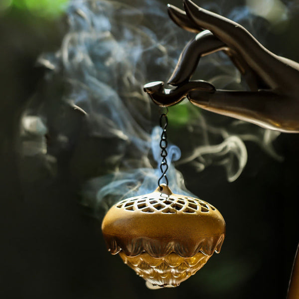 LED Buddha Hand Backflow Burner - close-up of golden lattice censer hanging from sculpted hand
