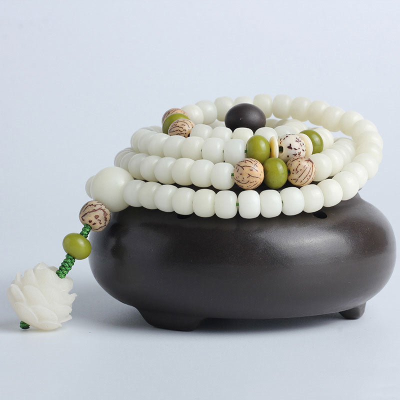 Bodhi Seed Lotus Mala - draped over ceramic incense burner with cloud cutouts, lotus pendant, ritual