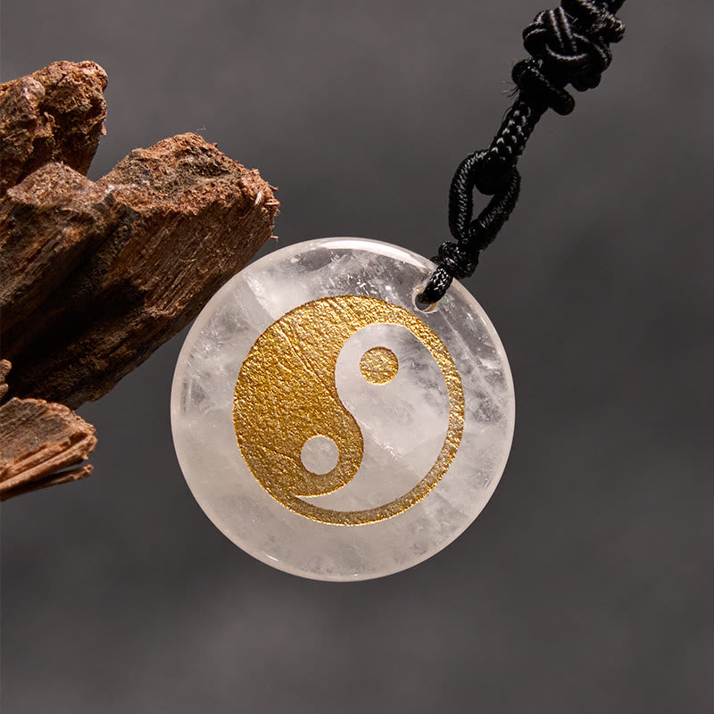 Yin Yang Crystal Necklace – Clear quartz crystal pendant with gold yin-yang symbol, translucent white stone with natural incl