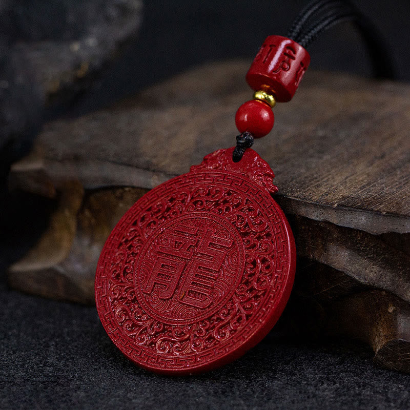 Cinnabar Dragon Pendant – Carved Shou longevity symbol amulet with intricate cloud border, Calming