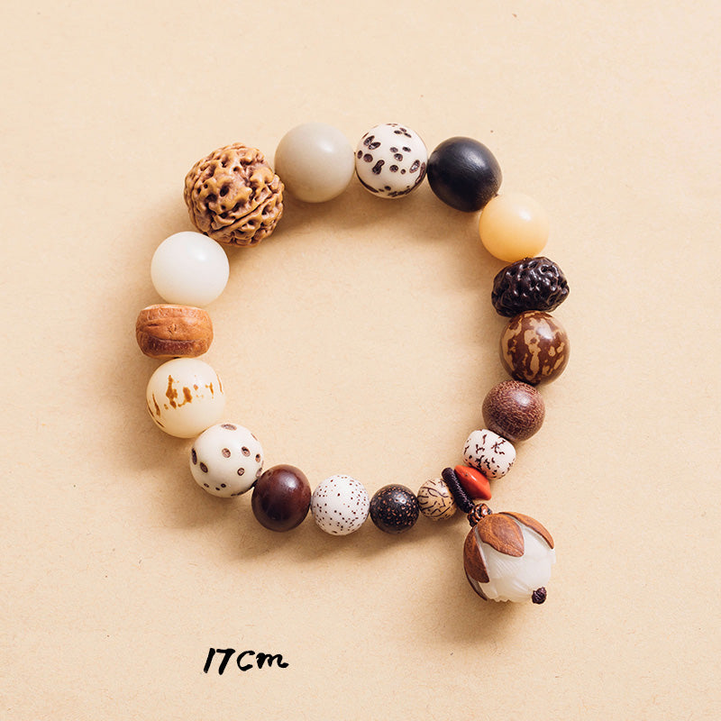 Bodhi Seed Lotus Bracelet – Overhead flat lay of natural seed beads with lotus charm, meditation