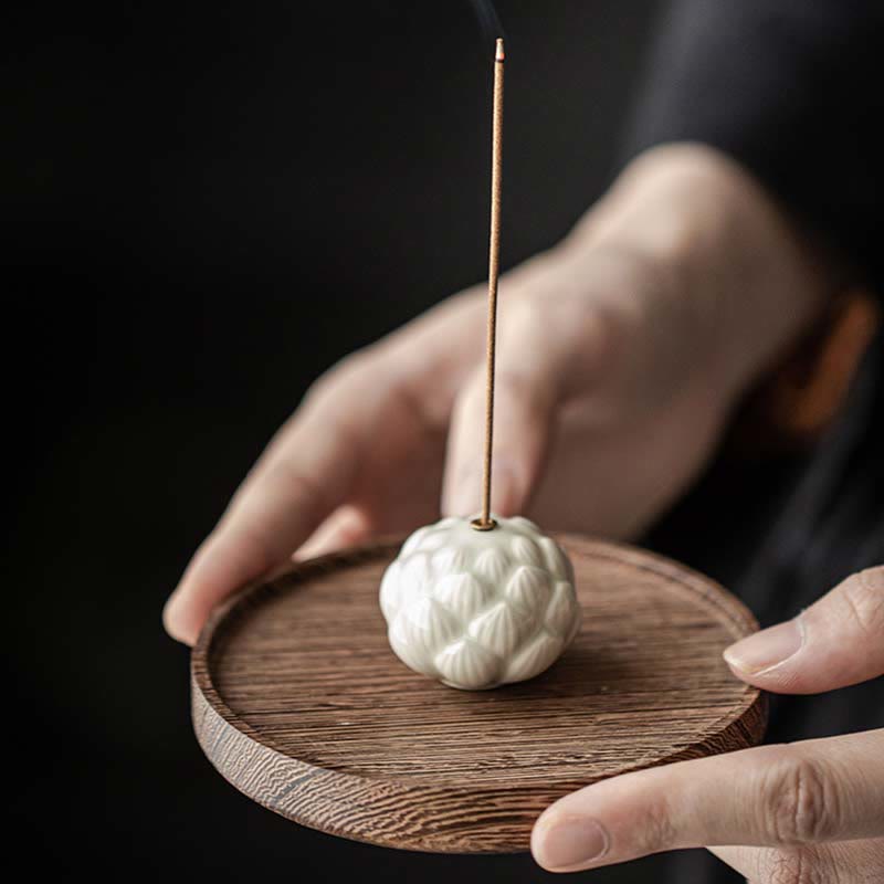 Ceramic Lotus Incense Burner with burning incense smoke, cream petal design, tranquil