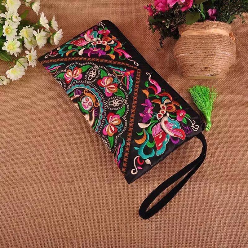 Dragon Butterfly Embroidery Wallet - Diagonal flat-lay on burlap with green tassel, Boho