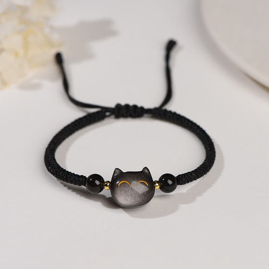Silver sheen obsidian cat head bracelet with black beads on adjustable black cord, minimalist gold-accented kitty protection jewelry