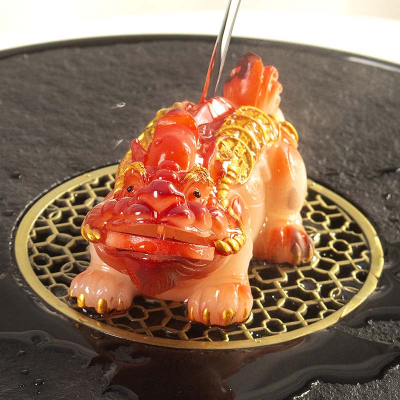 PiXiu Coin Tea Pet – Red-brown PiXiu being watered on black lattice tea tray, color changing