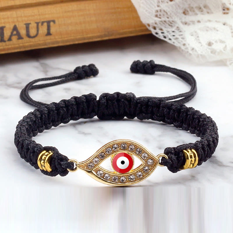 Black cord evil eye bracelet with gold red evil eye crystal charm, marble lifestyle