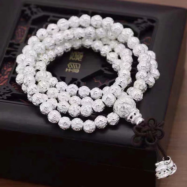 Om Mani Padme Hum Bracelet – Coiled silver mantra beads on carved wooden stand, Tibetan mala