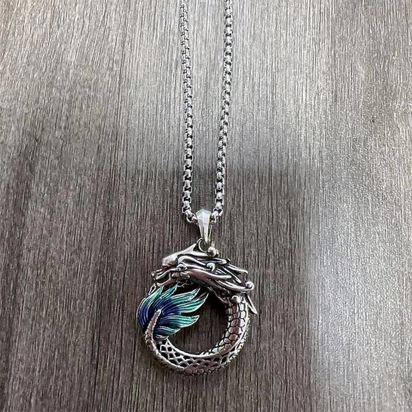 Tibetan Copper Dragon Necklace - Top-down on wood grain, enameled dragon on chain, Artisan