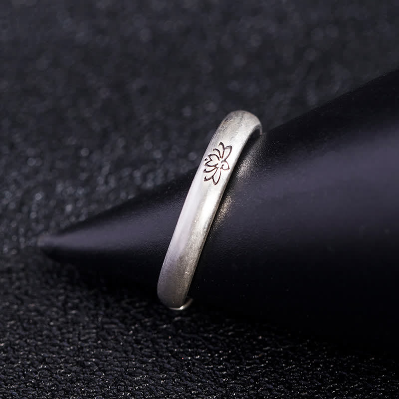 Lotus Enlightenment Ring - oxidized floral motif side view on matte black stand, handcrafted