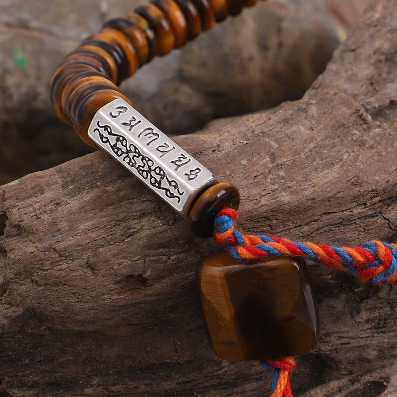 Tiger Eye Om Mani Padme Hum Bracelet - close-up of engraved mantra bead, tiger eye beads