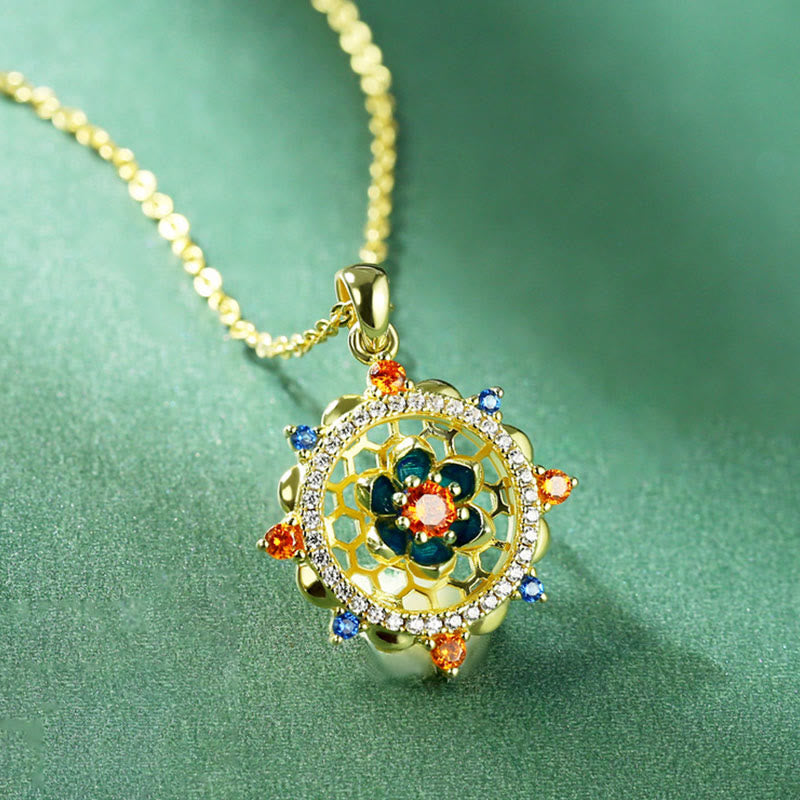 Sterling Silver Lotus Zircon Pendant with multicolor stones on teal fabric, spiritual