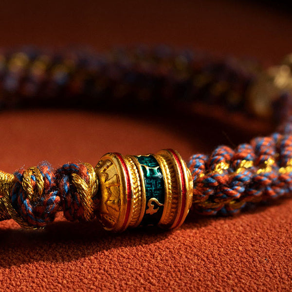 Om Mani Padme Hum Braided Bracelet – Macro detail of gold barrel bead with green enamel inlay on woven cord