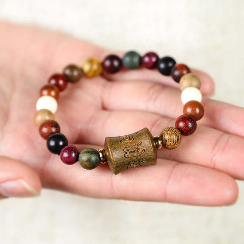 Multicolored Sandalwood Prayer Bracelet – Resting on open palm, multicolor wood bead variety